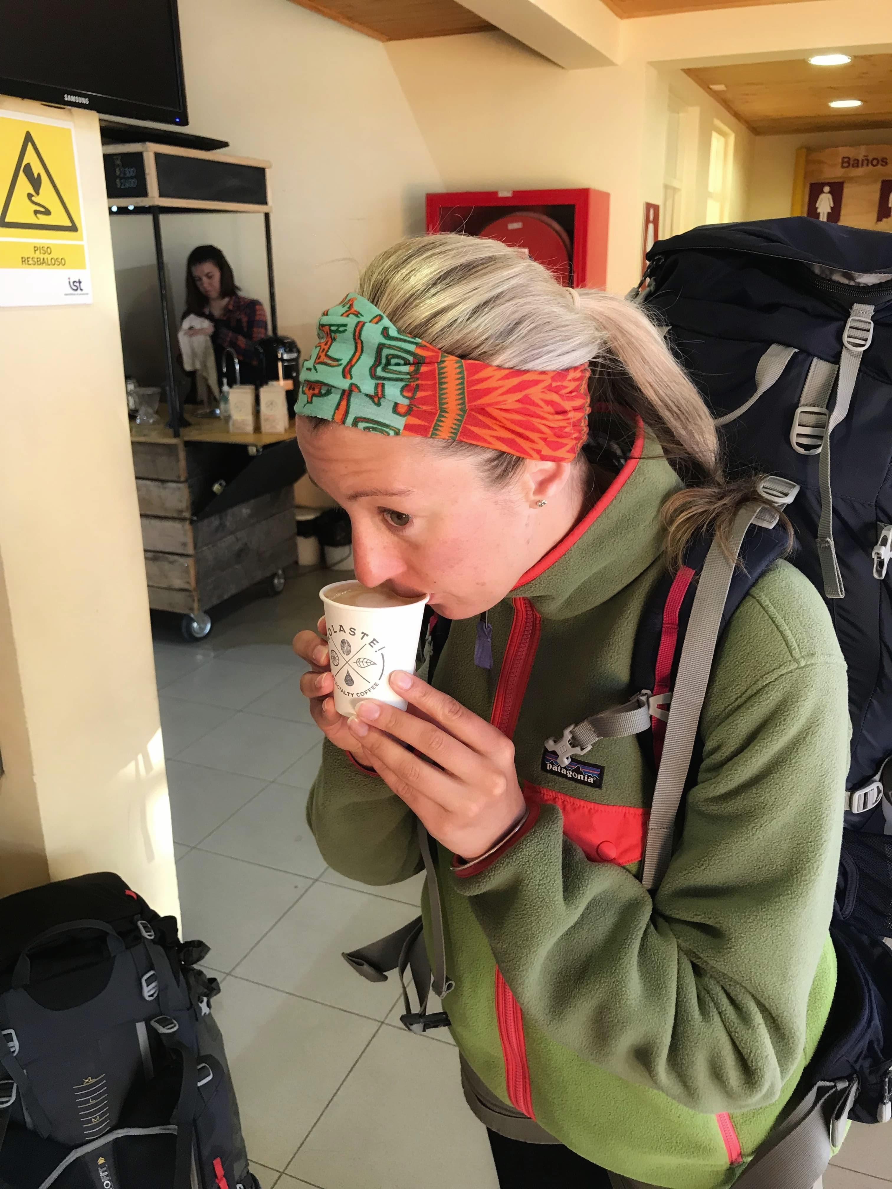 Jean drinking a latte at the bus stop in Puerto Natales